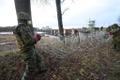 Reservists install razor wire on Estonia's eastern border.
