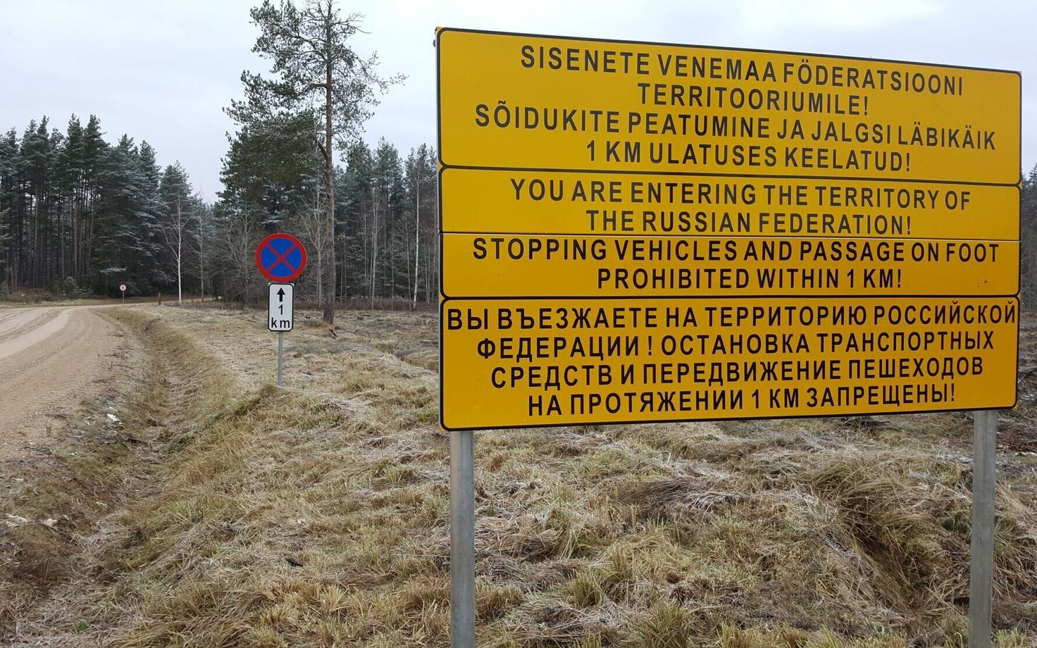 Trilingual warning sign posted along the road that cuts through the 'Saatse Boot'..