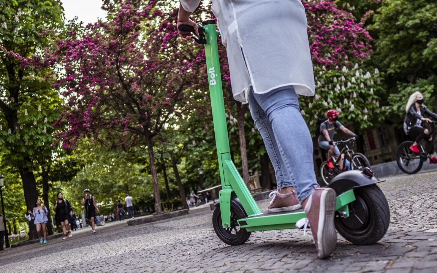 A woman riding a Bolt scooter.