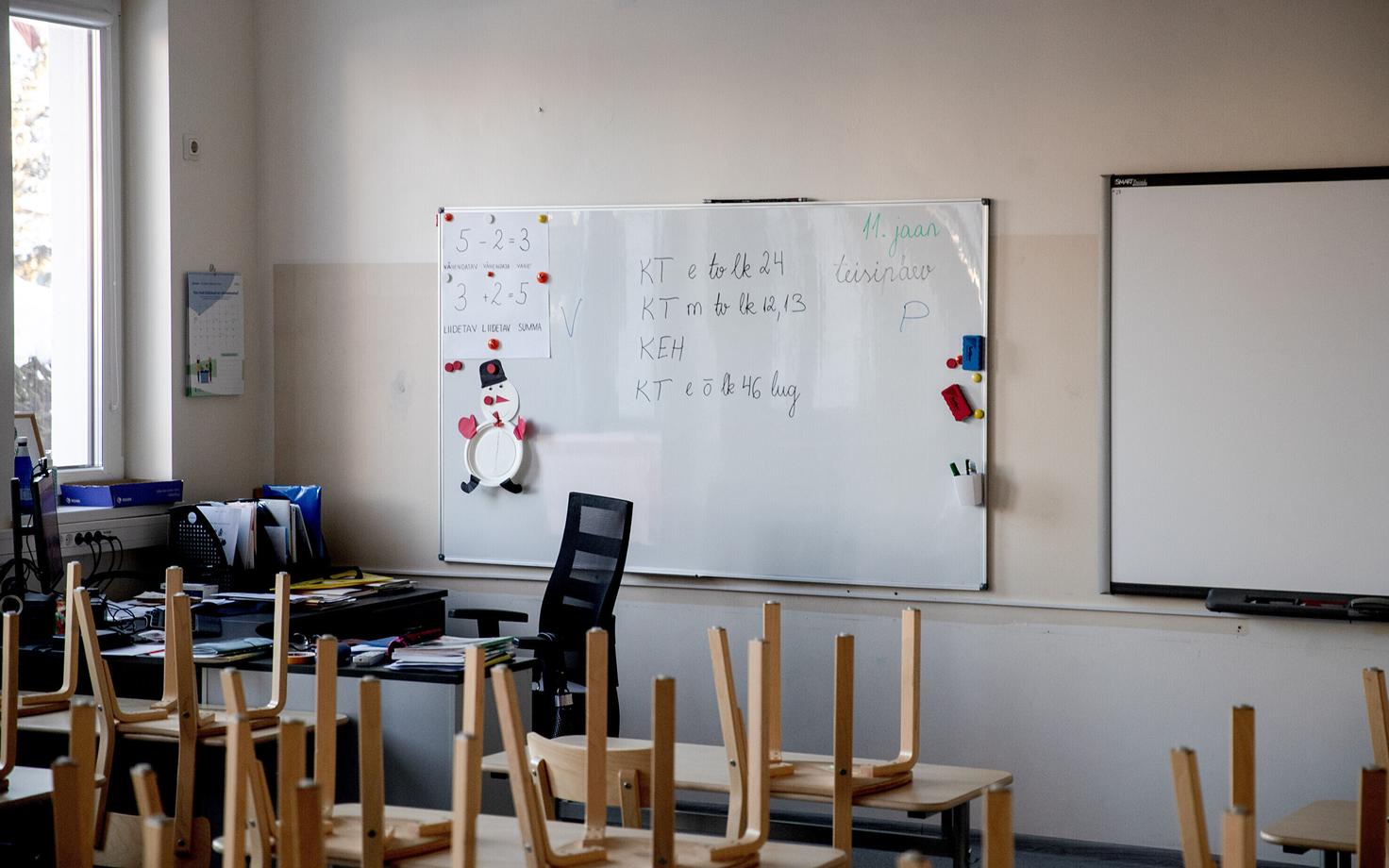 Whiteboard in a school classroom with Estonian writing on it. Photo is illustrative.