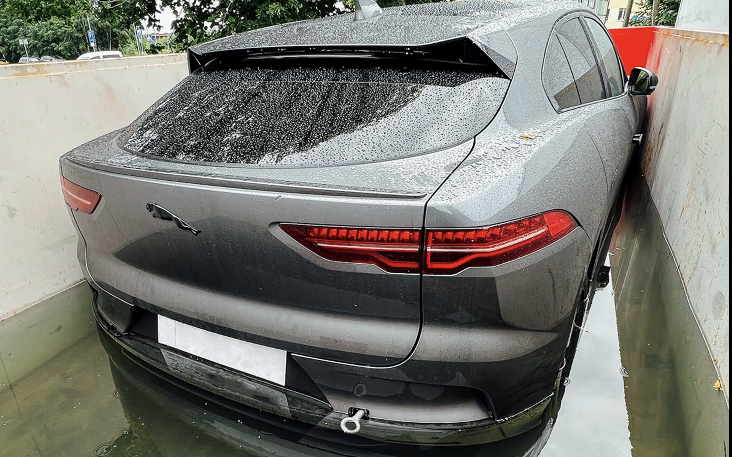 A Jaguar EV in an EV extinguishing container.