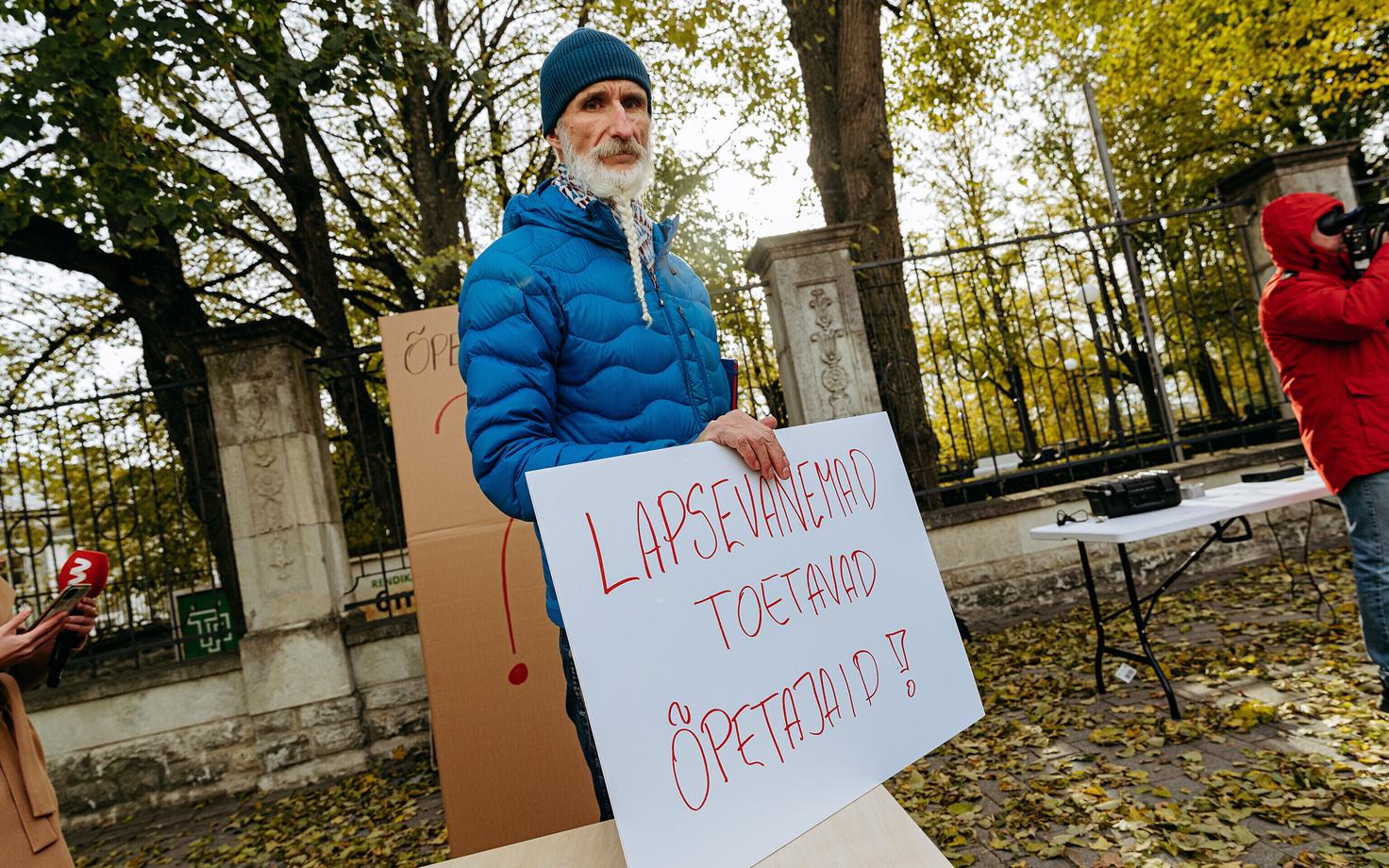 Protester holding a sign that reads