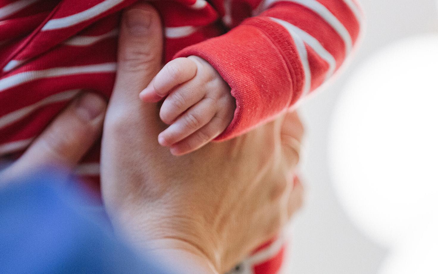 Caregiver holding a baby.