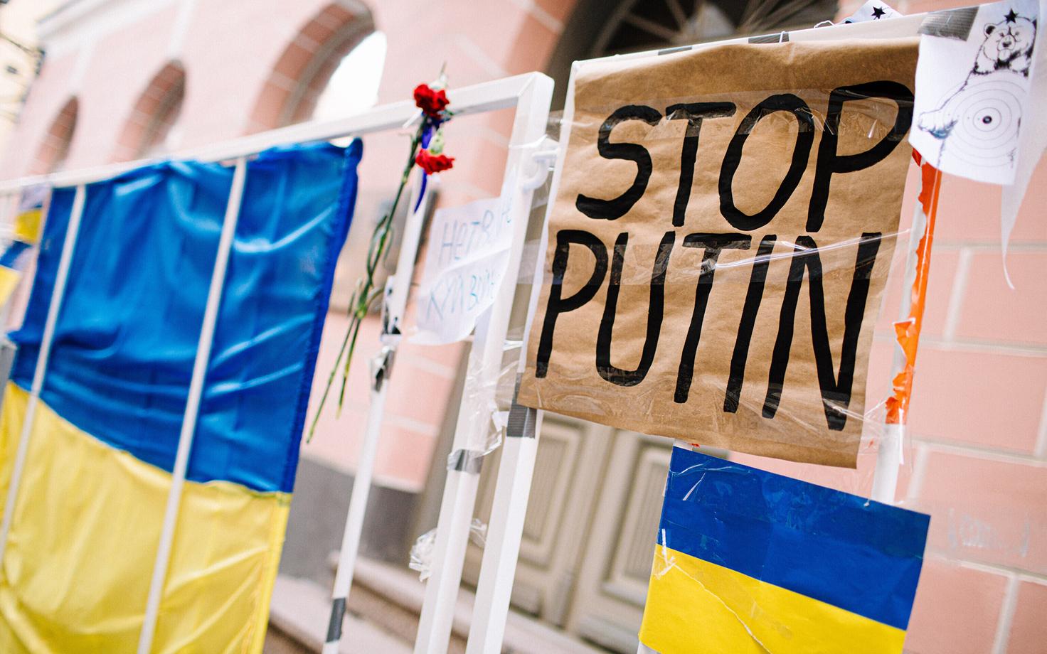 Banners and Ukrainian flags hung on temporary barriers outside the Russian Embassy in Tallinn.